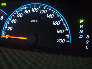 The illuminated speed gauge on dashboard represent the automotive part and technology concept related idea.