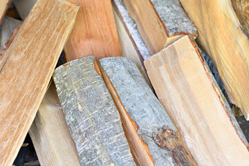 Neatly stacked firewood from Alder wood on full frame background