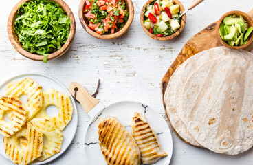 ingredients for mexican chicken tacos with vegetables and grilled pineapple