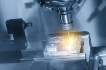 The CNC milling machine cutting the sample part with the small end-mill in light blue scene.Hi-precision CNC machining concept.