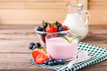 Strawberry yogurt and milk on a table. Selective focus. Copy space