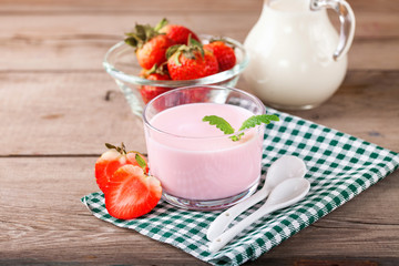 Strawberry yogurt and milk on a table. Selective focus. Copy space