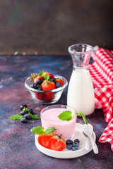 Strawberry yogurt and milk on a table. Selective focus. Copy space