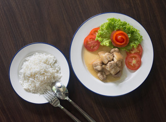Stir fried Salted pork with vegetables and rice in white dish on brown wooden table chinese food