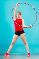 Fit woman with hula hoop doing exercise