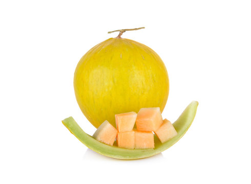 whole and portion cut fresh yellow melon with stem on white background