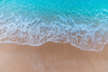 Fototapeta na wymiar Soft Wave Of Blue Ocean On Sandy Beach. Background. Selective focus.Background concept.