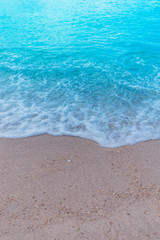 Soft Wave Of Blue Ocean On Sandy Beach. Background. Selective focus.Background concept.