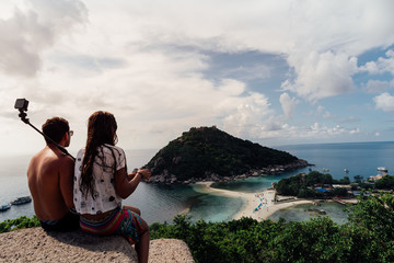 Happy Romantic Couple Enjoying at viewpoint on island,Travel Vacation Lifestyle summer Concept.Tropical paradise on the island of Koh nang yuan in Thailand,vintage tone