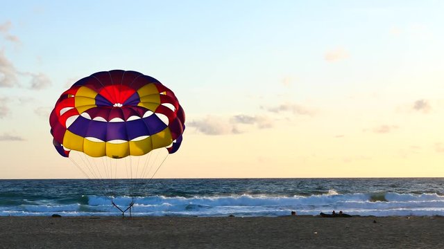 Parasailing provide services to tourists on sky in sunset time.