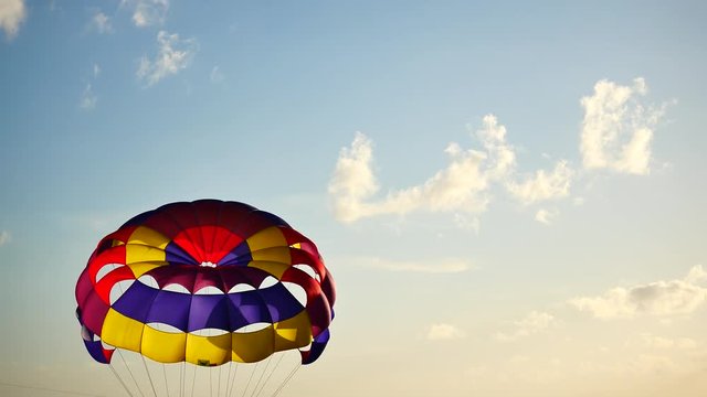 Parasailing provide services to tourists on sky in sunset time.