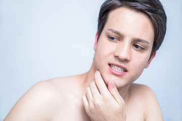 young man checking his facial skin. men's skincare concept.