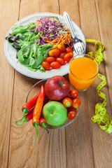 Healthy concept with mixed fruits and vegetables on wooden background