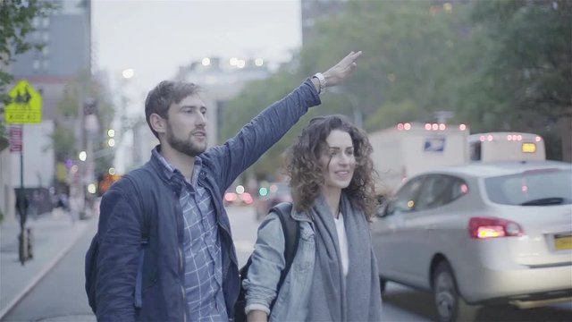 Couple hailing taxi