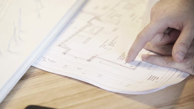 Architech examining blueprint