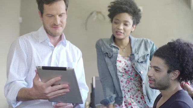 Colleagues looking at digital tablet together
