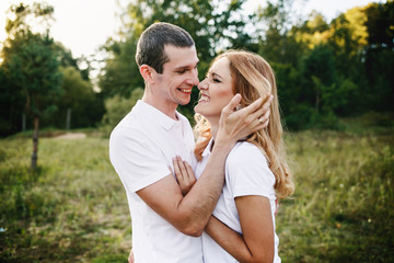 Cute couple laughing outdoors in the summertime