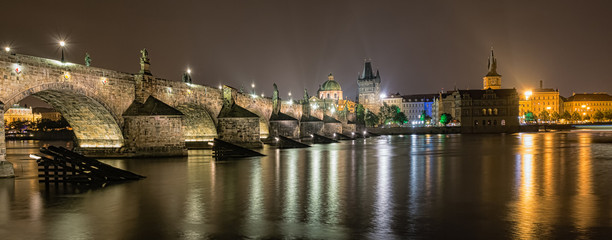 Charles Bridge and buildings along the Vltava at night