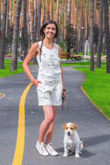 Woman posing in a park with white dog