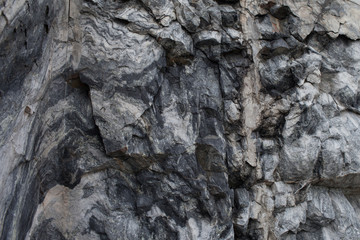 A large rock of grey marble. The texture of the marble. Natural Stone pattern. Natural Stone texture. Natural Stone background. Porcelain textures.