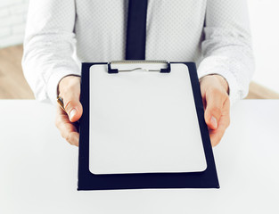 Clipboard on a white table. close up