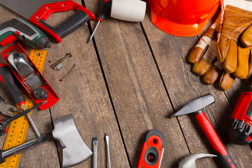 Assorted work tools on wood background