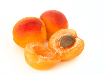  Ripe apricots with seed solated on white background. Healthy fruit eating.