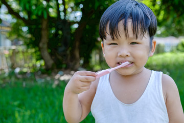 Little beautiful asian boy brushing teeth, healthy concept.Close up