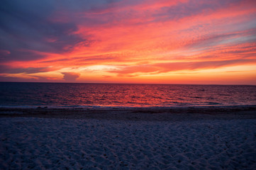 Evening sunset to the sea on the beach of Is Arutas on the island of Sardinia