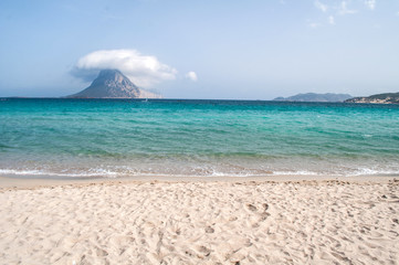 San Teodoro - sandy beach with a pointed hill in the distance on the island of Sardinia