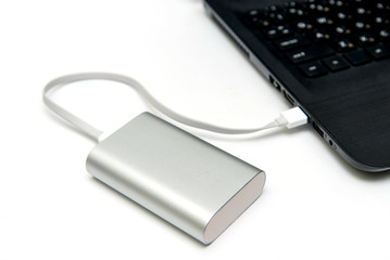 Laptop with a powerbank on white table