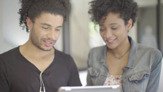 Couple using digital tablet together
