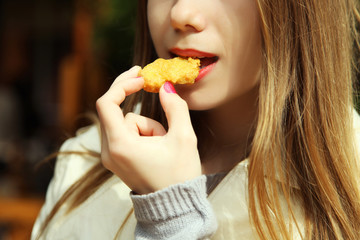  girl is eating nuggets