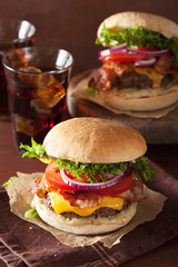 bacon cheese burger with beef patty, tomato and onion