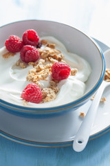 yogurt with granola and raspberry for healthy breakfast