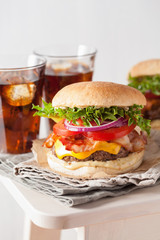 bacon cheese burger with beef patty, tomato and onion