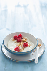 yogurt with granola and raspberry for healthy breakfast