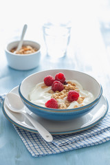 yogurt with granola and raspberry for healthy breakfast