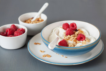 yogurt with granola and raspberry for healthy breakfast