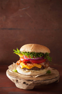 bacon cheese burger with beef patty, tomato and onion