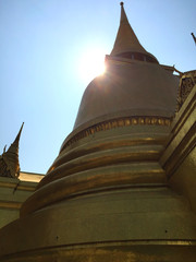 Golden pagoda with sunlight and blue sky at Wat Phra Kaew, Temple of the Emerald Buddha , Bangkok Thailand