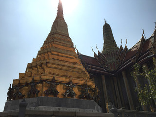 Golden pagoda with Garuda guardian on base at Wat Phra Kaew, Temple of the Emerald Buddha , Bangkok Thailand