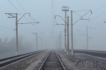 railroad goes to horizon in fog