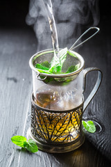 Brewing fresh green tea on old wooden table