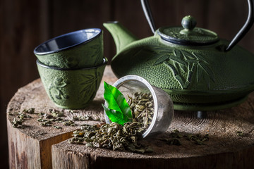 Aromatic green tea on old wooden stump