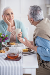 Fototapeta na wymiar casual senior couple talking and having breakfast at home