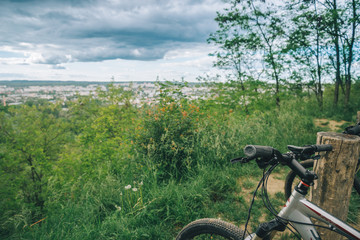 two bicycles stand wth city view on background