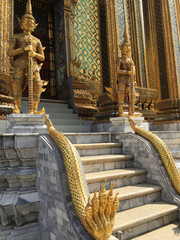 Twin golden giant guardian in front of gate at Wat Phra Kaew, Temple of the Emerald Buddha , Bangkok Thailand