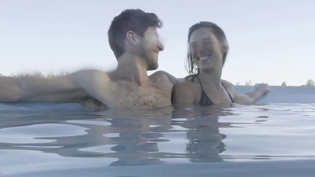 Couple relaxing in pool together