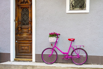 Fototapeta na wymiar pink bike standing by the wall